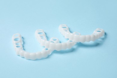 Photo of Dental mouth guards on light blue background. Bite correction
