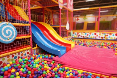 Photo of Slides and many colorful balls in ball pit