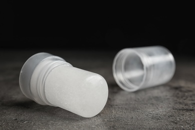 Photo of Natural crystal alum deodorant and cap on grey table