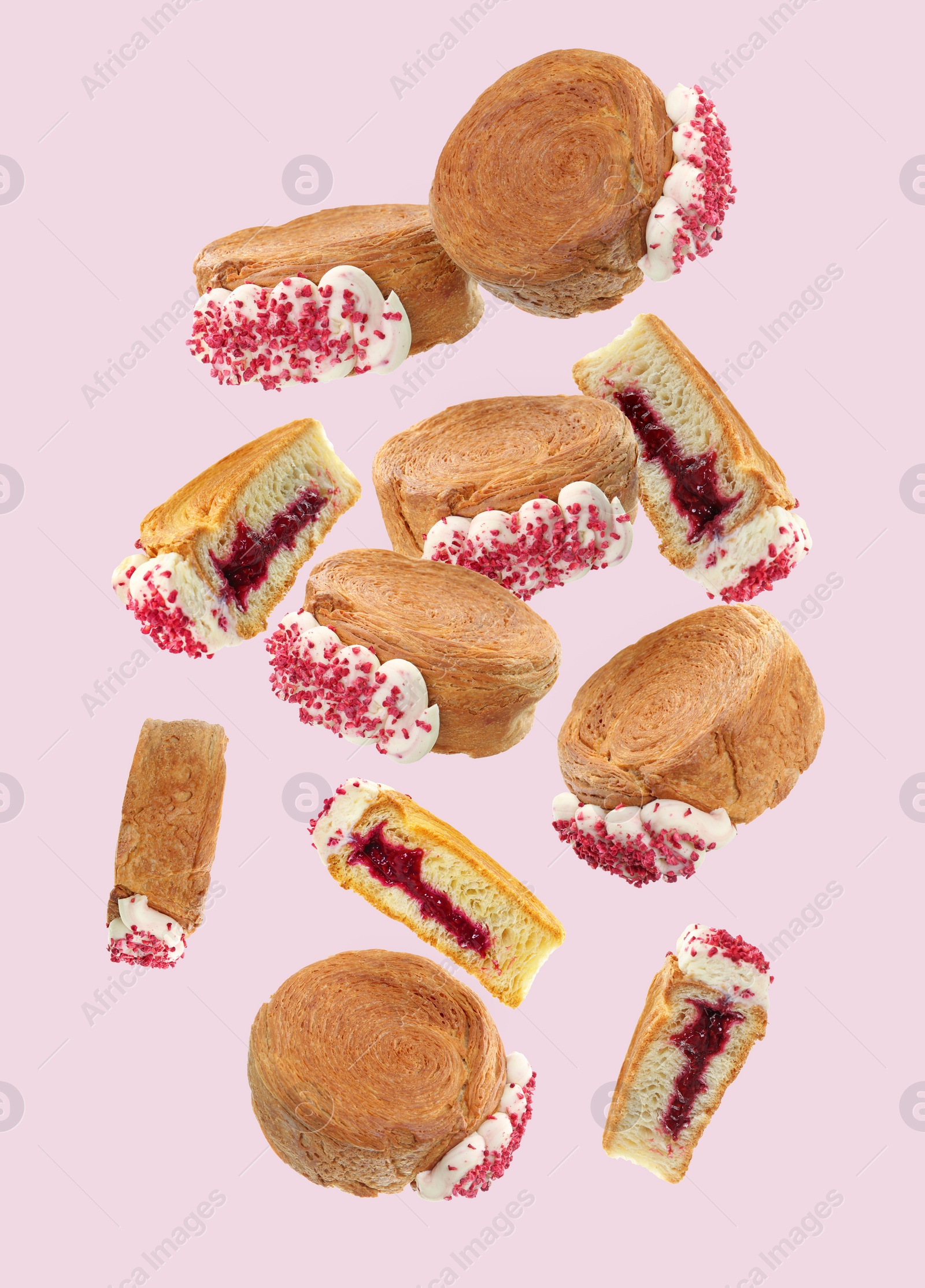 Image of Delicious round croissants in air on pink background. Puff pastry