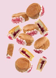 Image of Delicious round croissants in air on pink background. Puff pastry