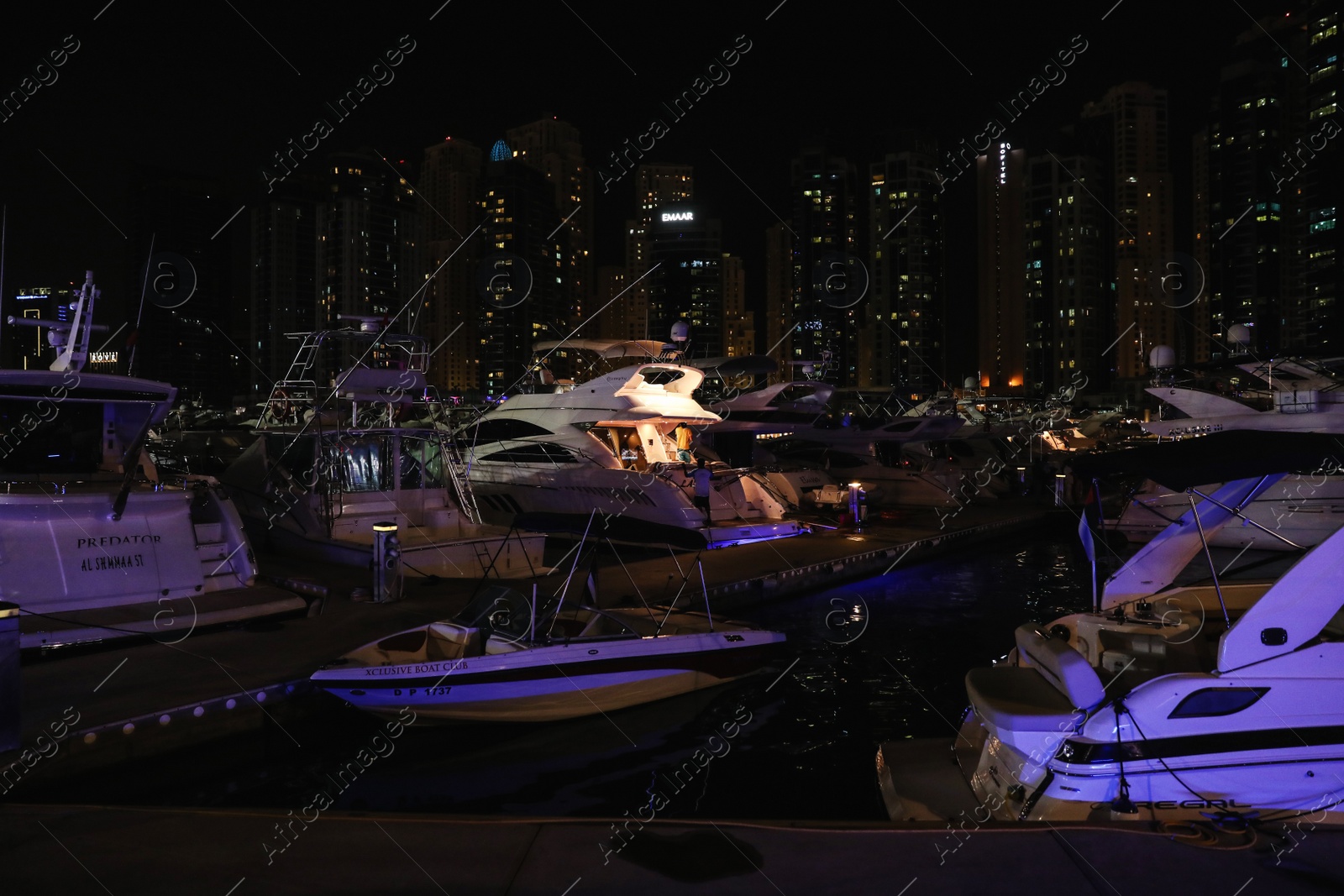 Photo of DUBAI, UNITED ARAB EMIRATES - NOVEMBER 03, 2018: Pier with luxury yachts at night