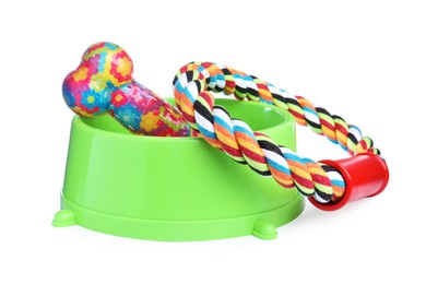 Feeding bowl and toys for pet on white background