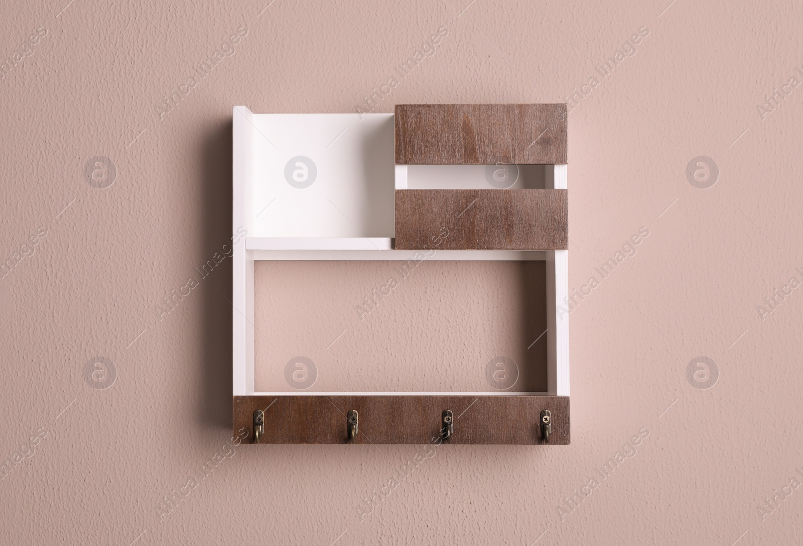 Photo of Wooden hanger for keys on color wall