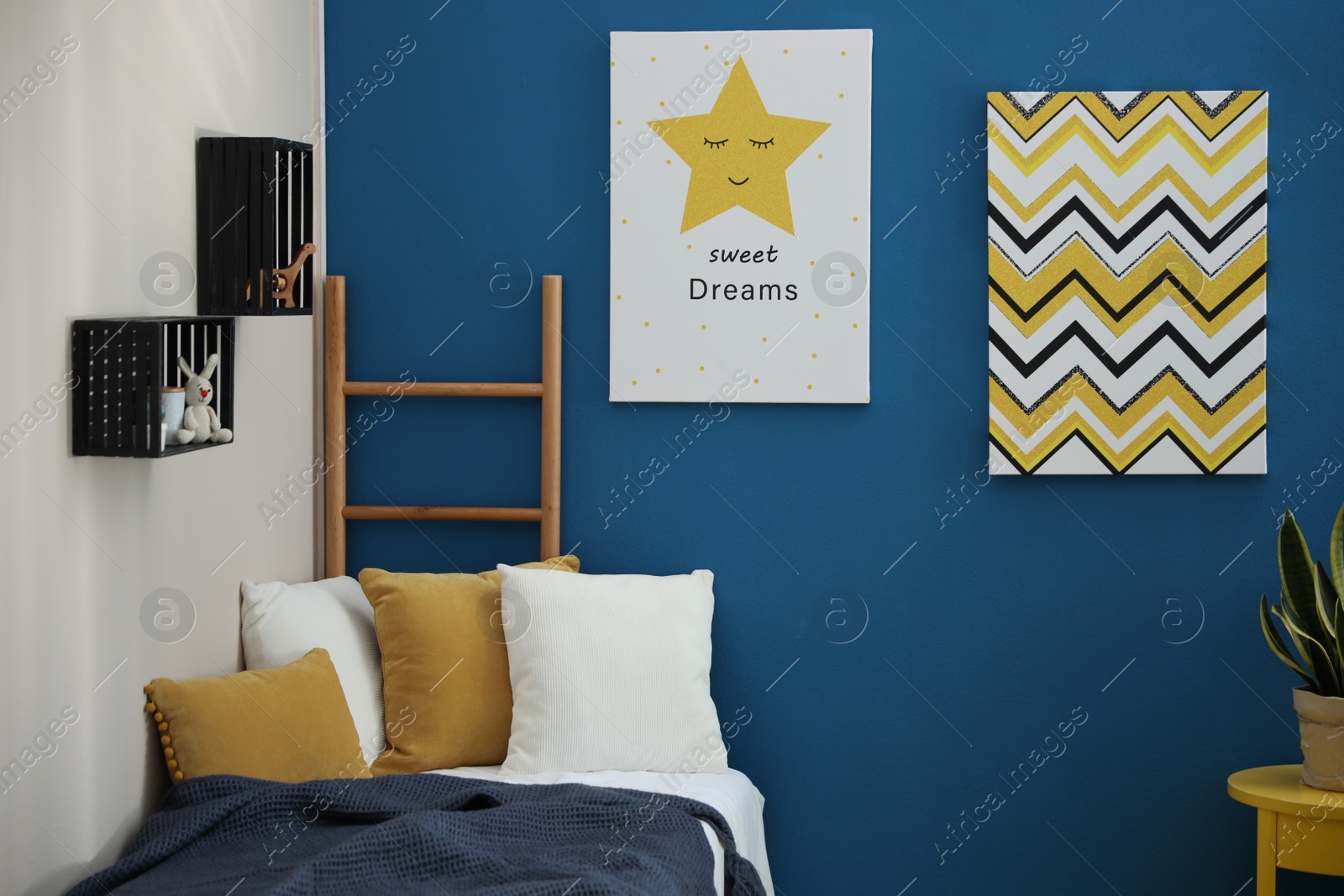 Photo of Cute pictures on blue wall. Children's room interior design