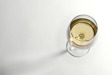 Photo of Glass of delicious wine on white background, above view