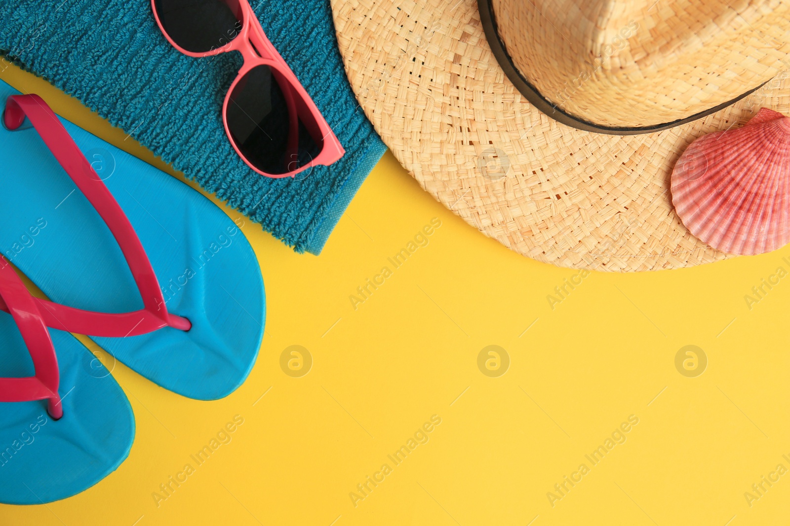 Photo of Flat lay composition with different beach accessories on yellow background. Space for text