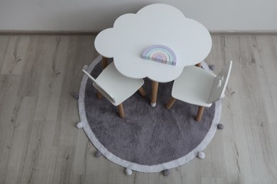 Photo of Small table and chairs in baby room, above view