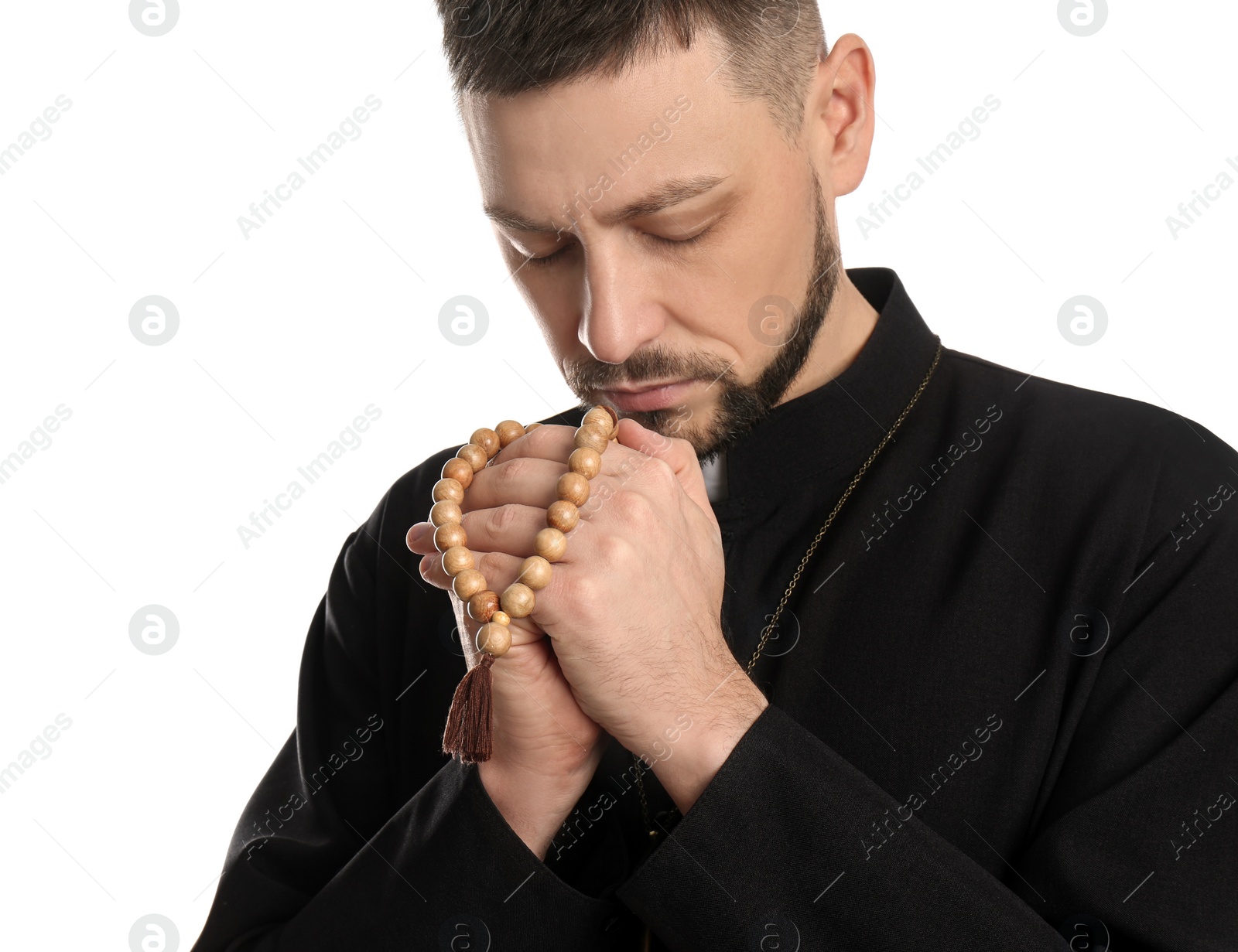 Photo of Priest with beads praying on white background