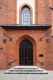 Photo of Entrance of building with beautiful arched wooden door