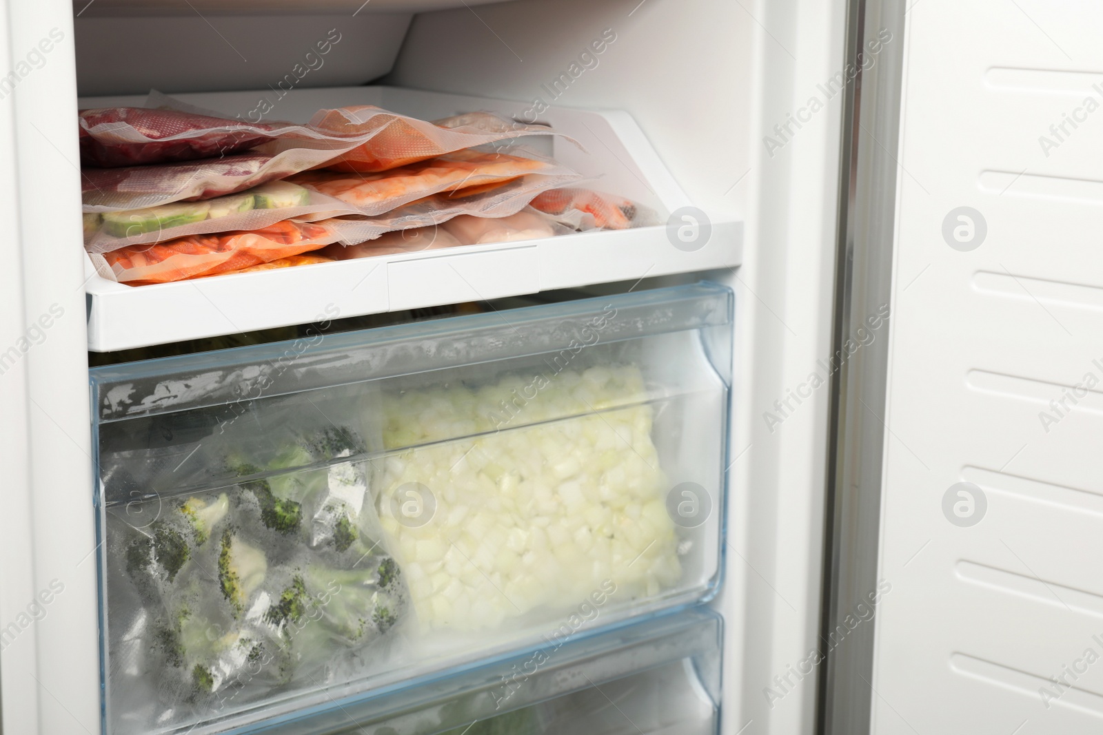 Photo of Vacuum bags with different products in fridge. Food storage