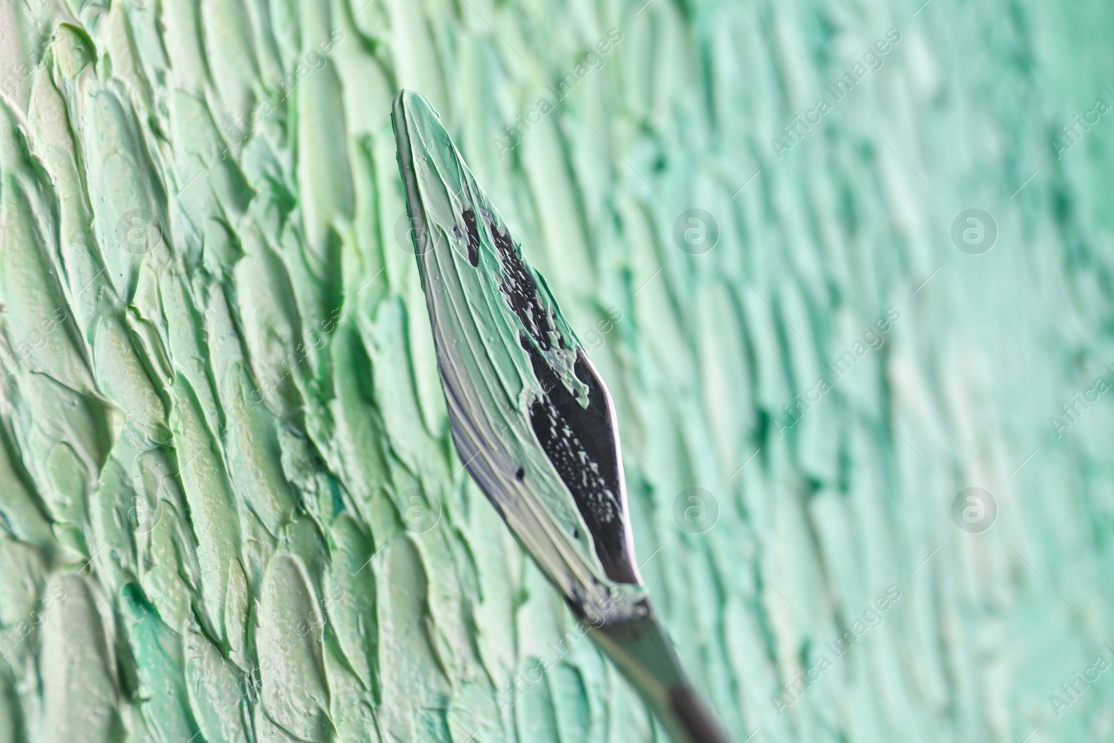 Photo of Abstract colorful artwork painting with spatula, closeup view