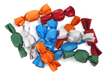 Photo of Many candies in colorful wrappers on white background, top view