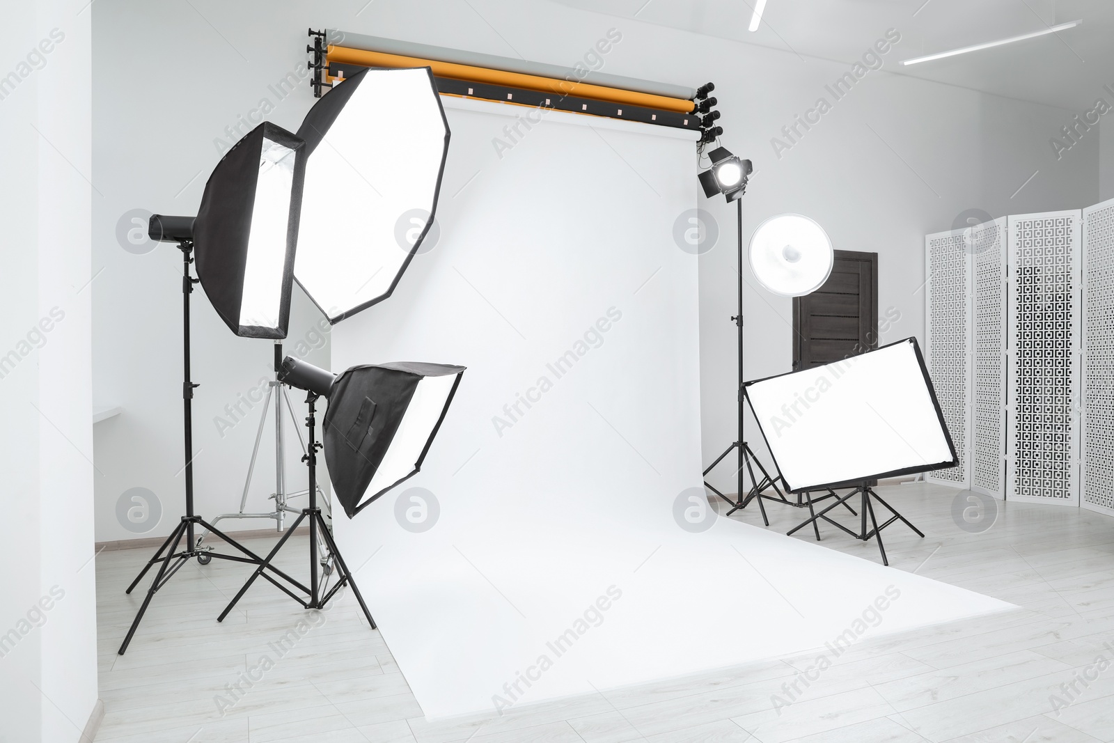 Photo of Interior of modern photo studio with professional lighting equipment