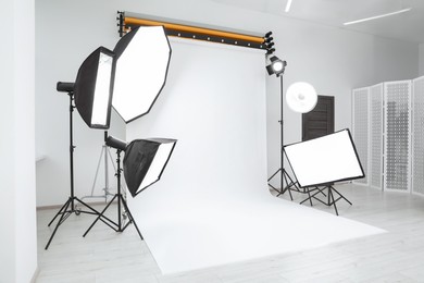 Photo of Interior of modern photo studio with professional lighting equipment