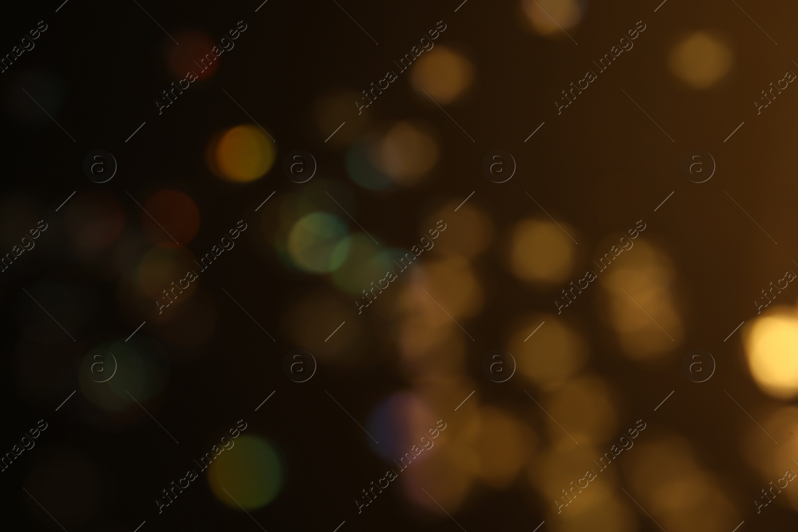 Photo of Blurred view of shiny glitter on black background. Bokeh effect