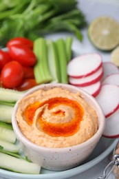 Photo of Plate with delicious hummus and fresh vegetables on table, closeup