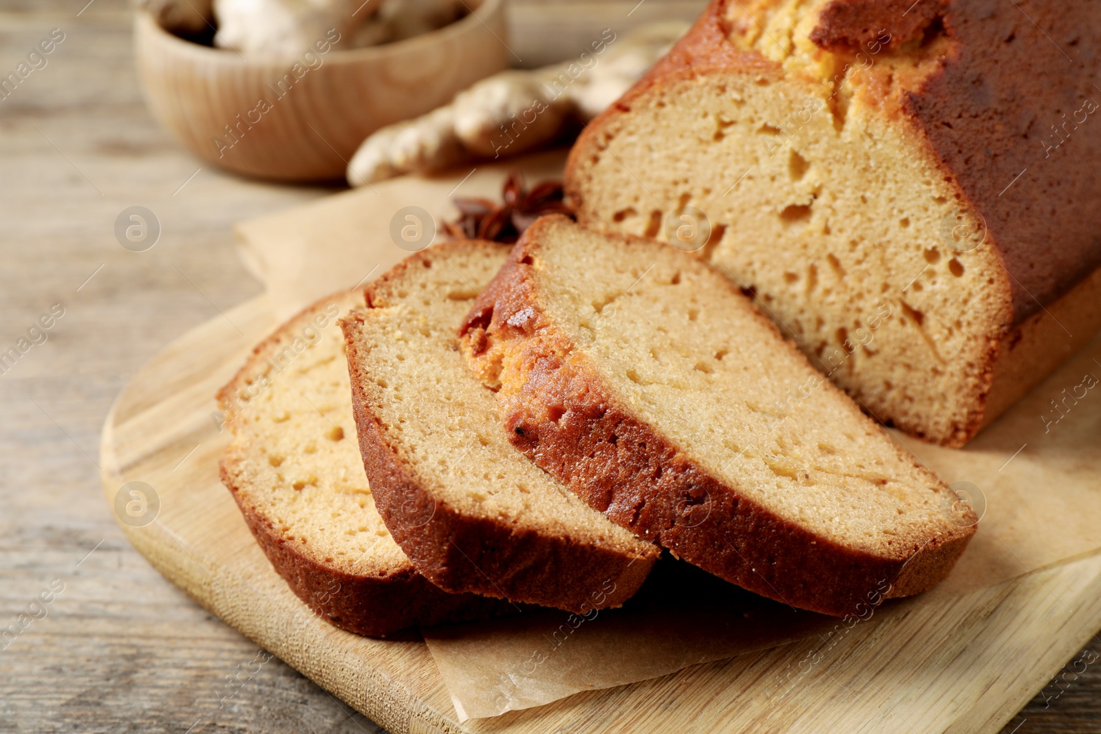 Photo of Sliced delicious gingerbread cake on wooden table, closeup