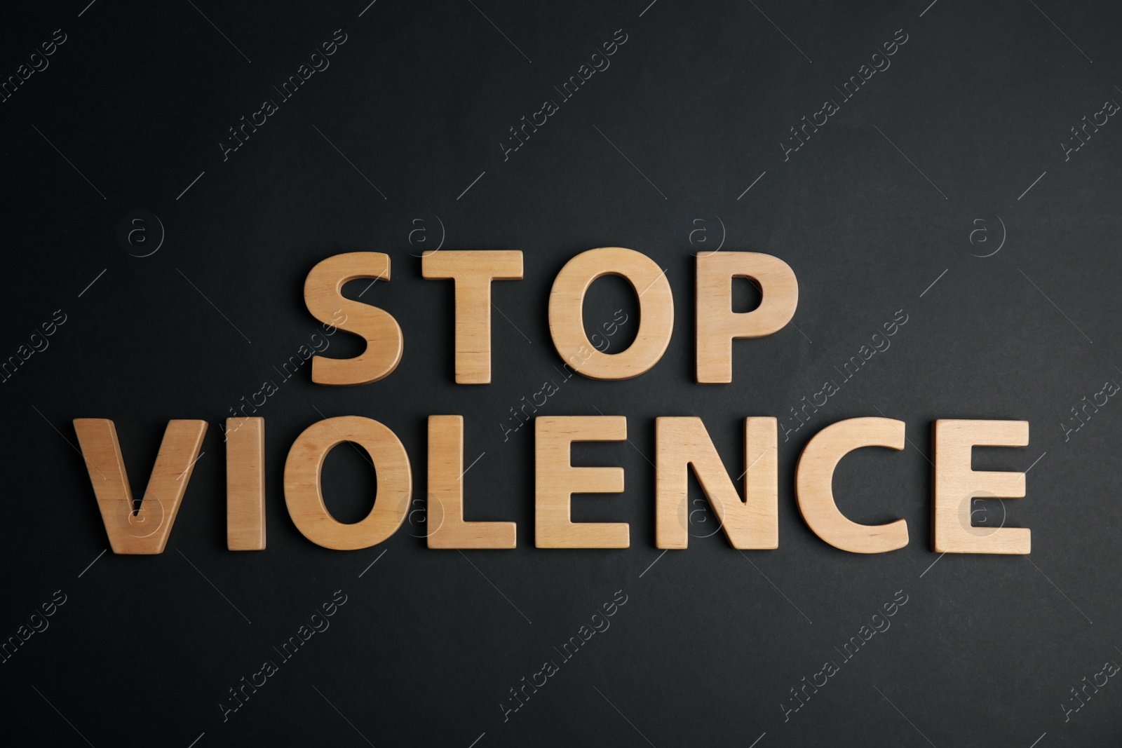 Photo of Phrase STOP VIOLENCE on black background, flat lay