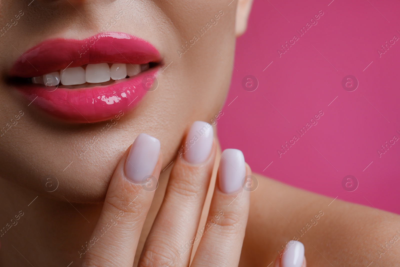 Photo of Closeup view of woman with beautiful lips on pink background. Space for text