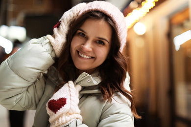 Photo of Beautiful young woman on city street. Winter vacation