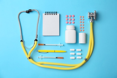 Flat lay composition with medical equipment and pills on color background