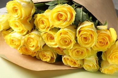 Beautiful bouquet of yellow roses on table, closeup