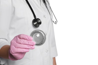 Doctor holding blister of emergency contraception pill on white background, closeup