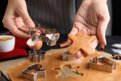 Woman making Christmas cookies at table, closeup