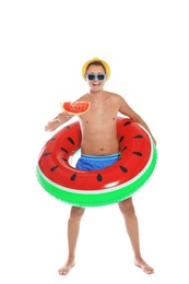 Photo of Shirtless man with inflatable ring and watermelon on white background