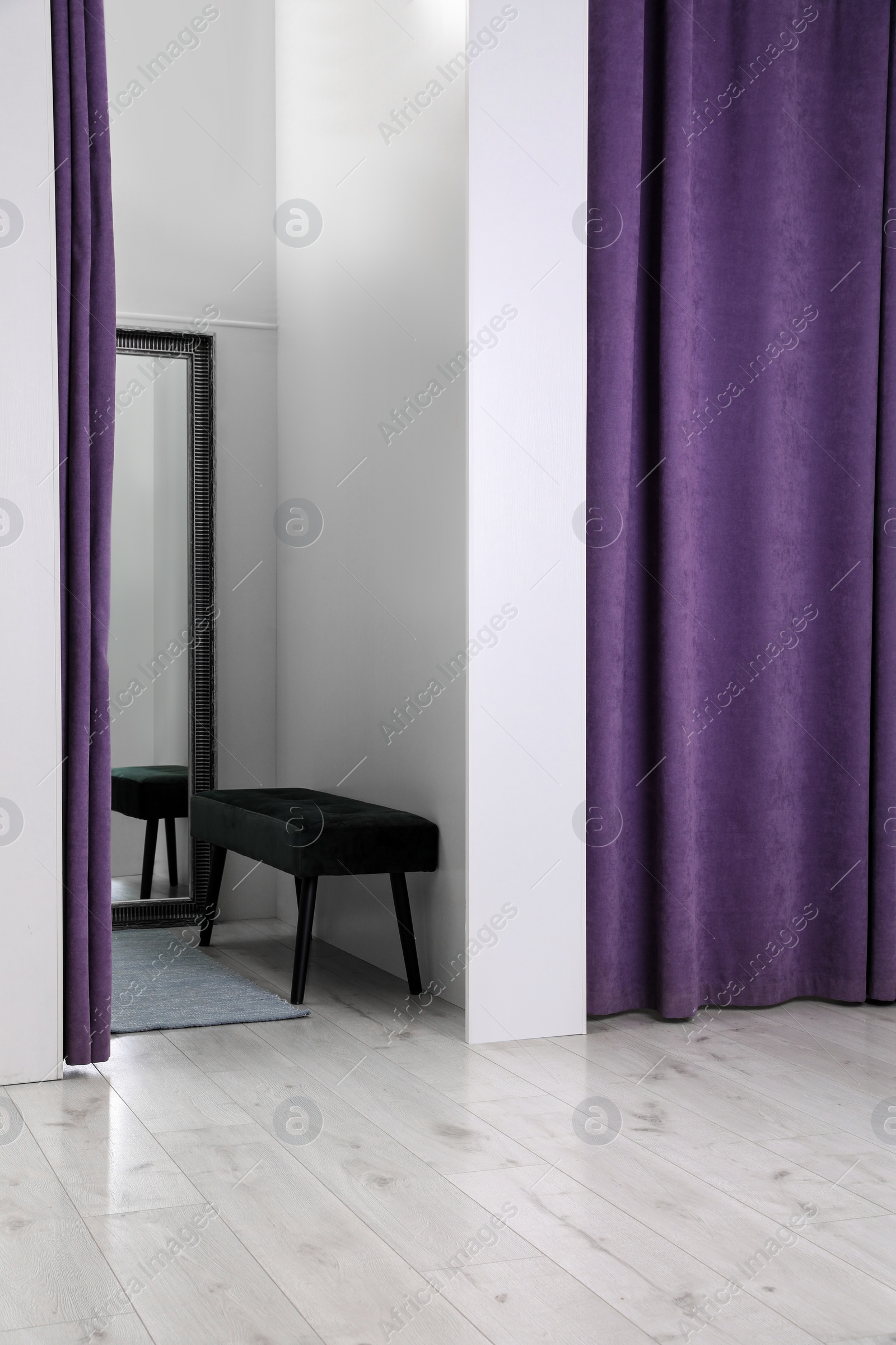 Photo of Empty dressing room in fashion store. Stylish interior