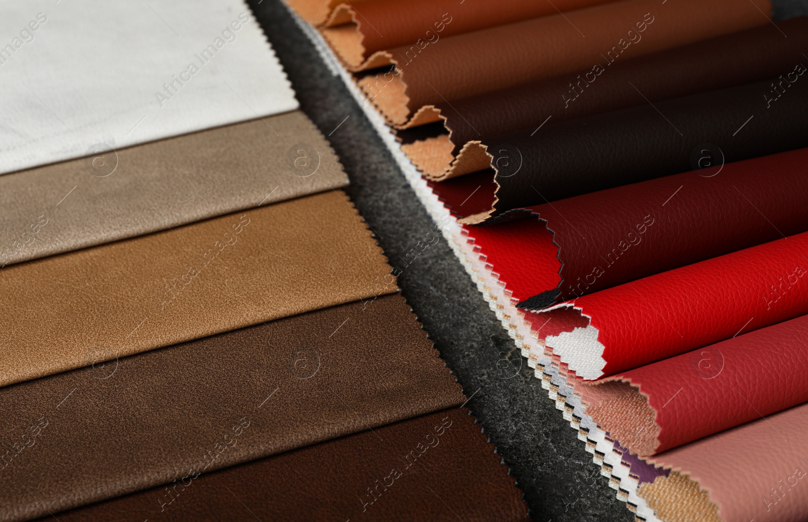 Photo of Leather samples on grey stone background, closeup