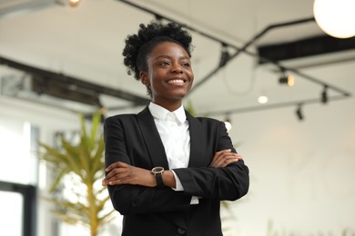 Happy woman with crossed arms in office. Lawyer, businesswoman, accountant or manager