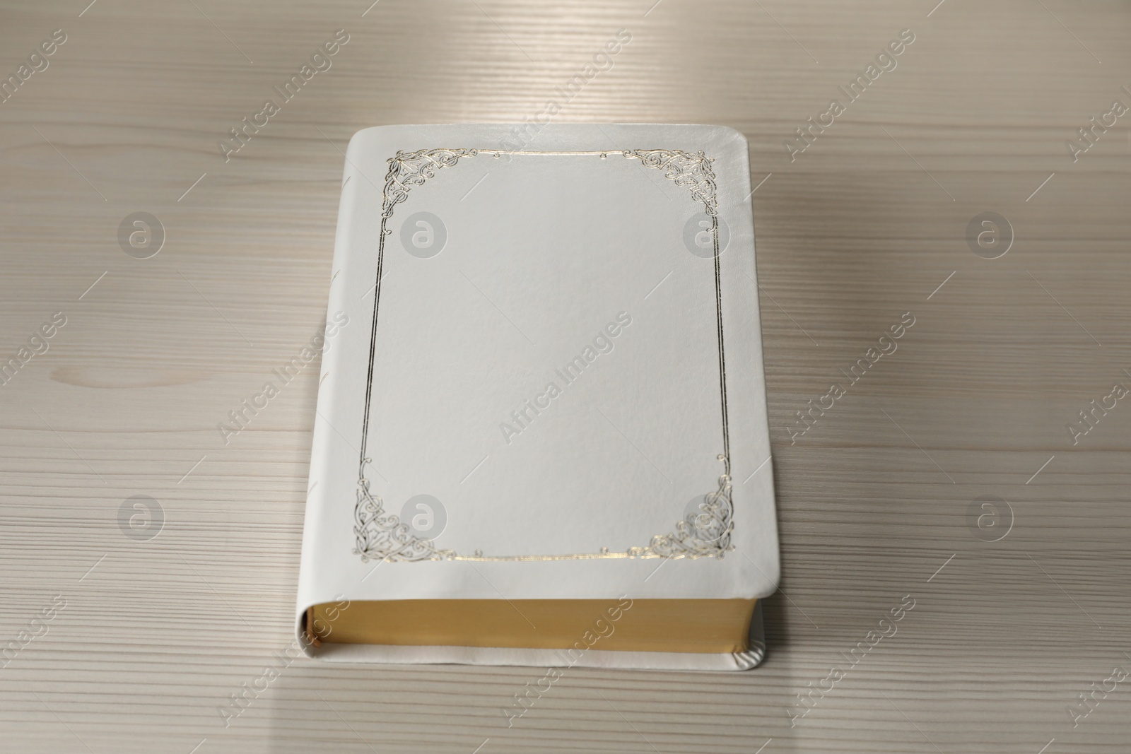Photo of Bible on white wooden table. Christian religious book