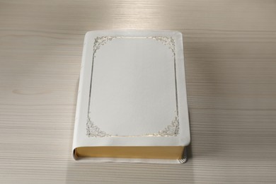Photo of Bible on white wooden table. Christian religious book