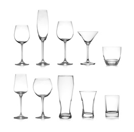 Set of different empty glasses on white background