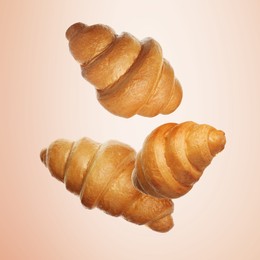 Golden croissants falling on coral gradient background