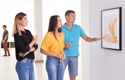 Photo of Young people at exhibition in art gallery