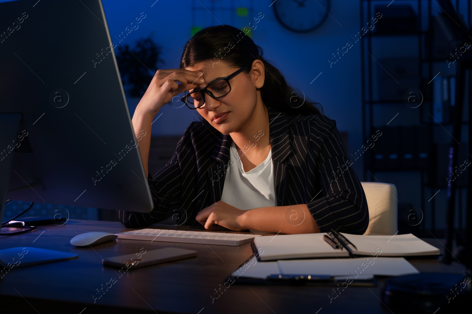 Photo of Tired businesswoman working at night in office