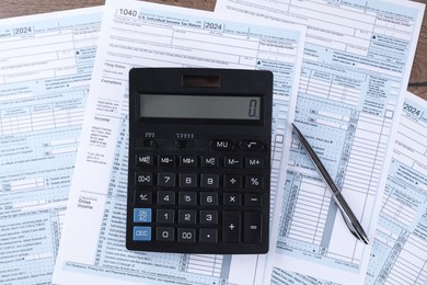 Photo of Tax accounting. Calculator, documents and pen on table, flat lay