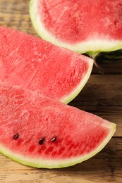 Photo of Delicious fresh watermelon slices on wooden table, closeup