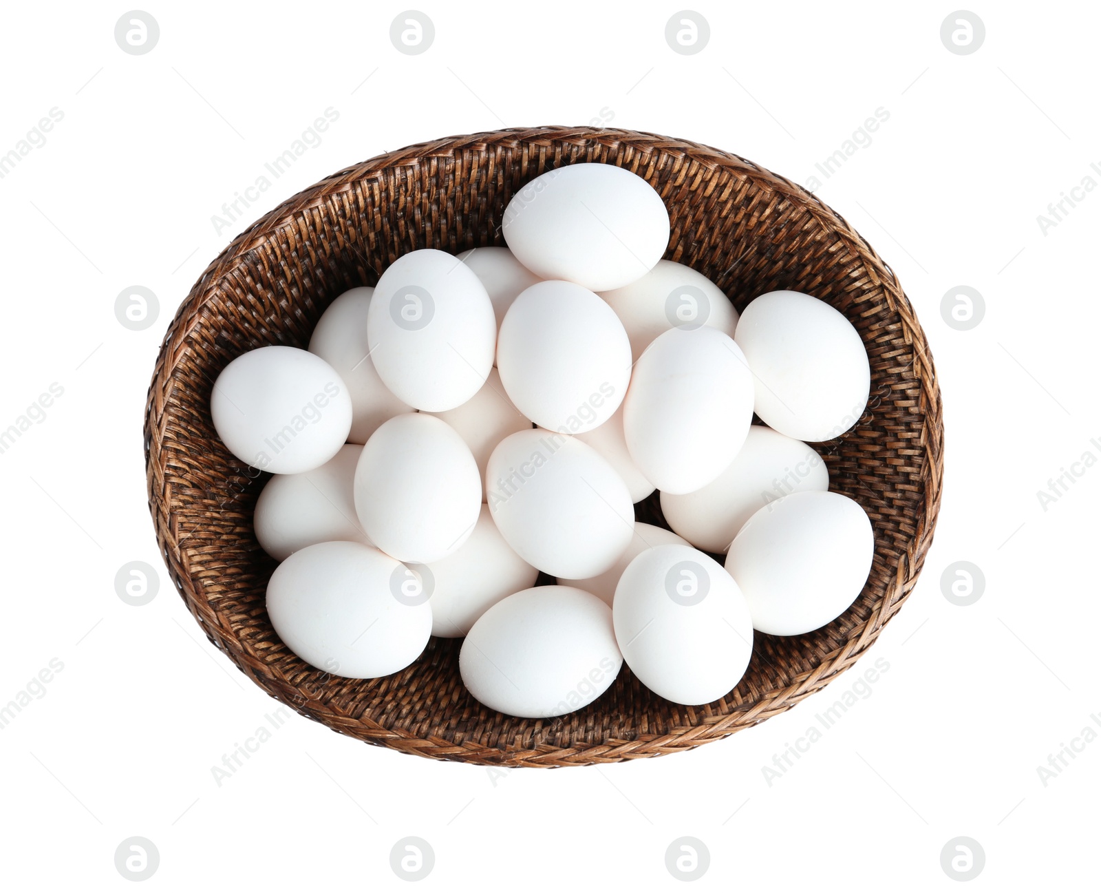 Photo of Chicken eggs in wicker bowl isolated on white, top view