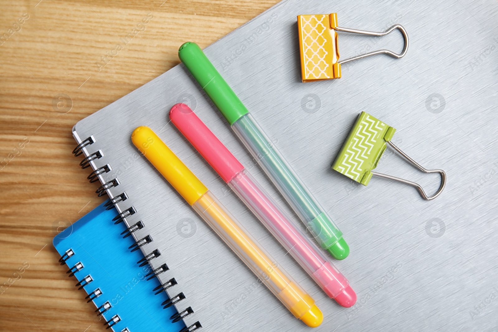 Photo of Different school stationery on wooden background, flat lay