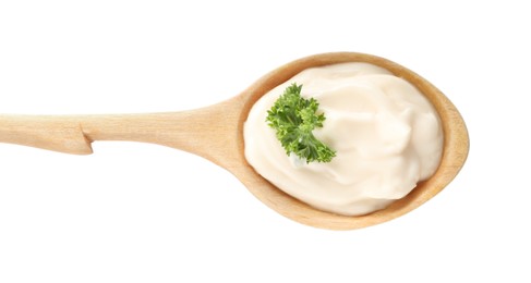 Wooden spoon with tasty mayonnaise and parsley isolated on white, top view