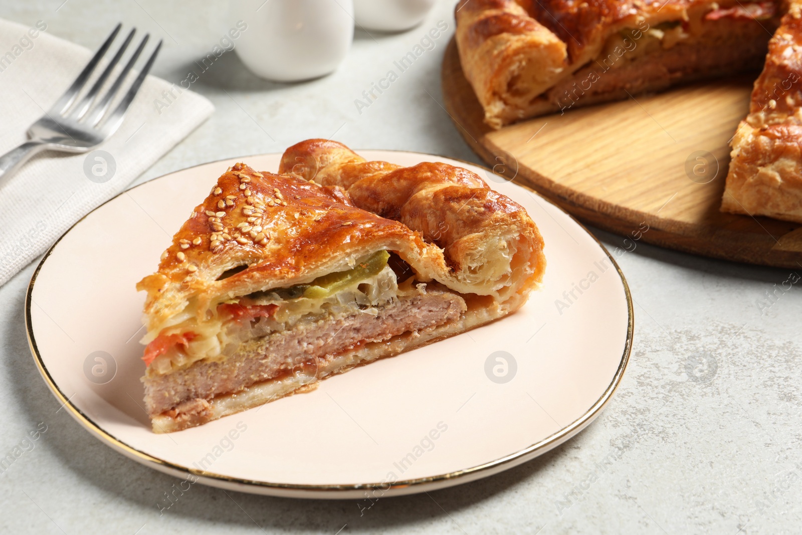 Photo of Piece of tasty homemade pie with filling on light grey table