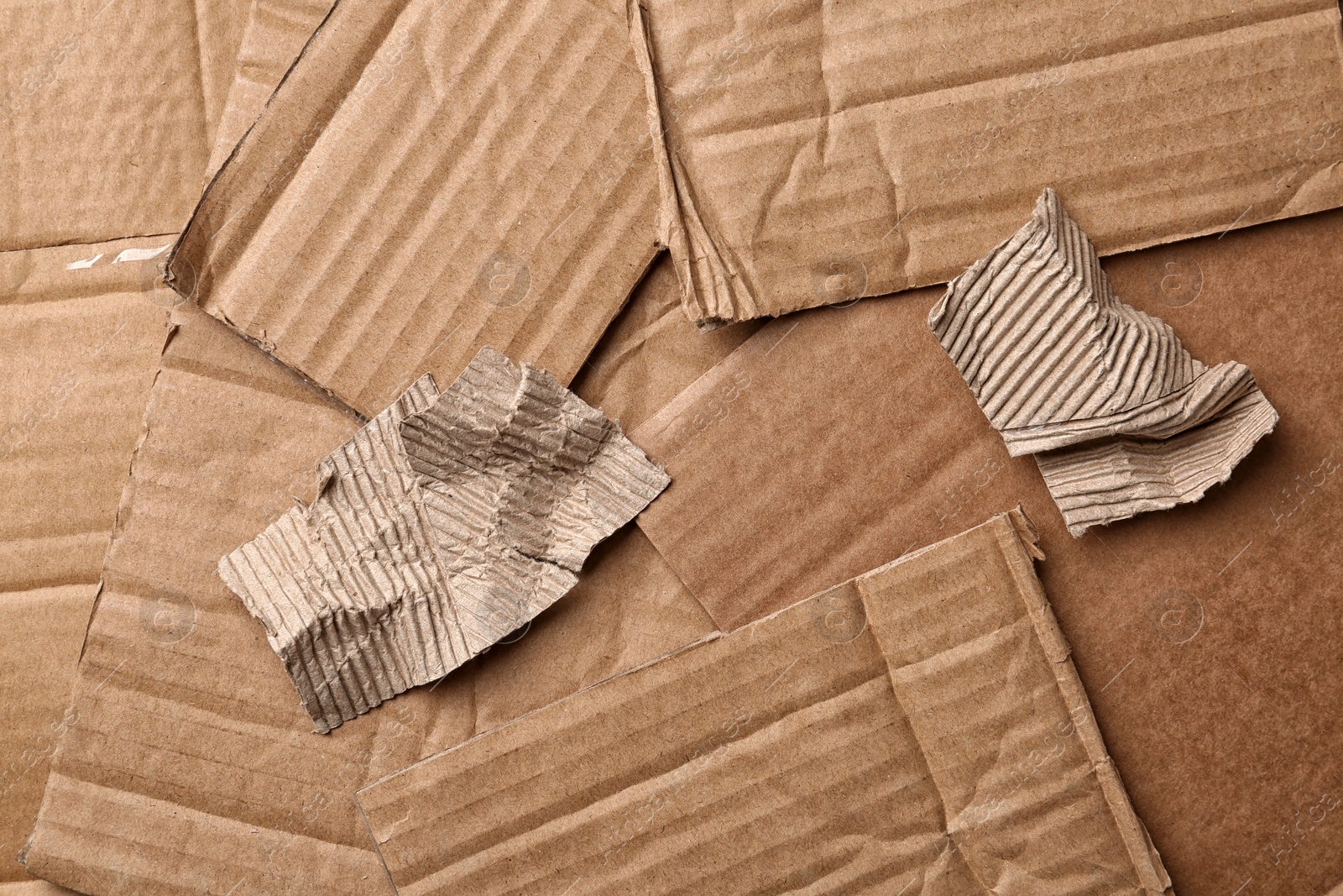 Photo of Pieces of cardboard as background, top view. Recycling problem