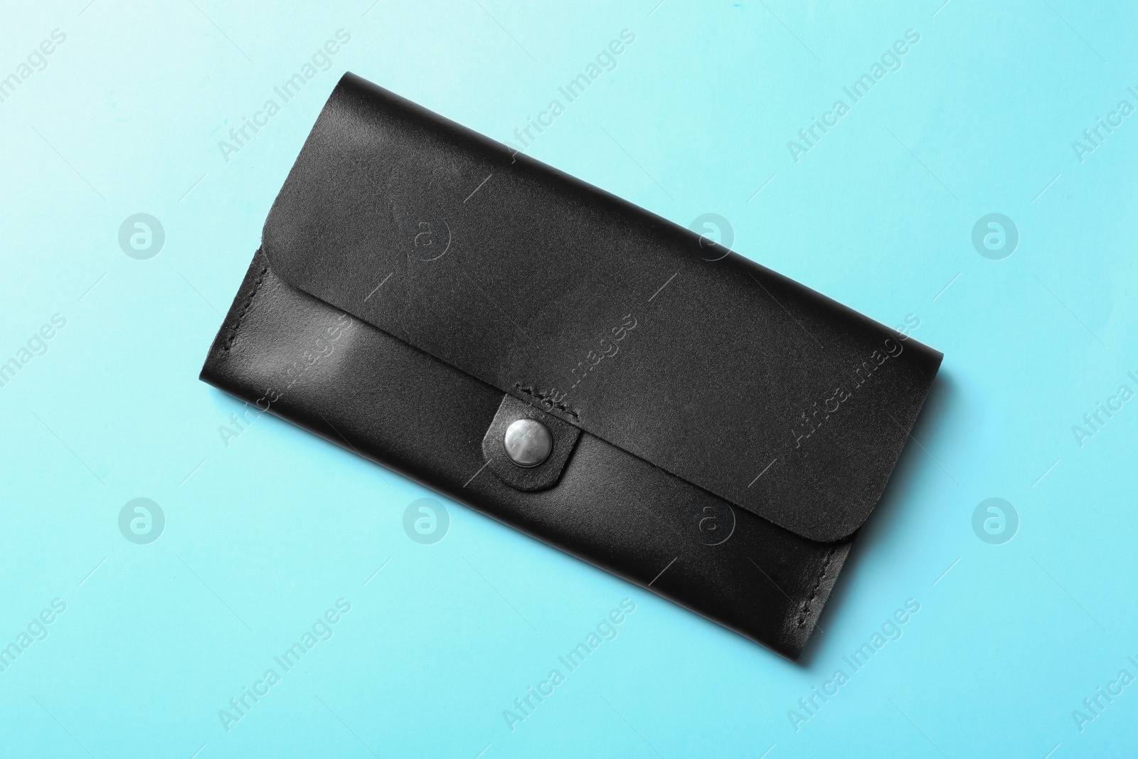 Photo of Stylish wallet on color background, top view