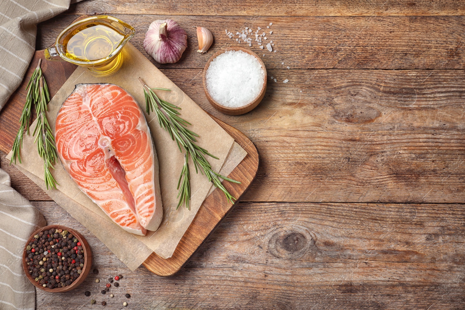 Photo of Flat lay composition with fresh raw salmon and products on wooden table, space for text. Fish delicacy