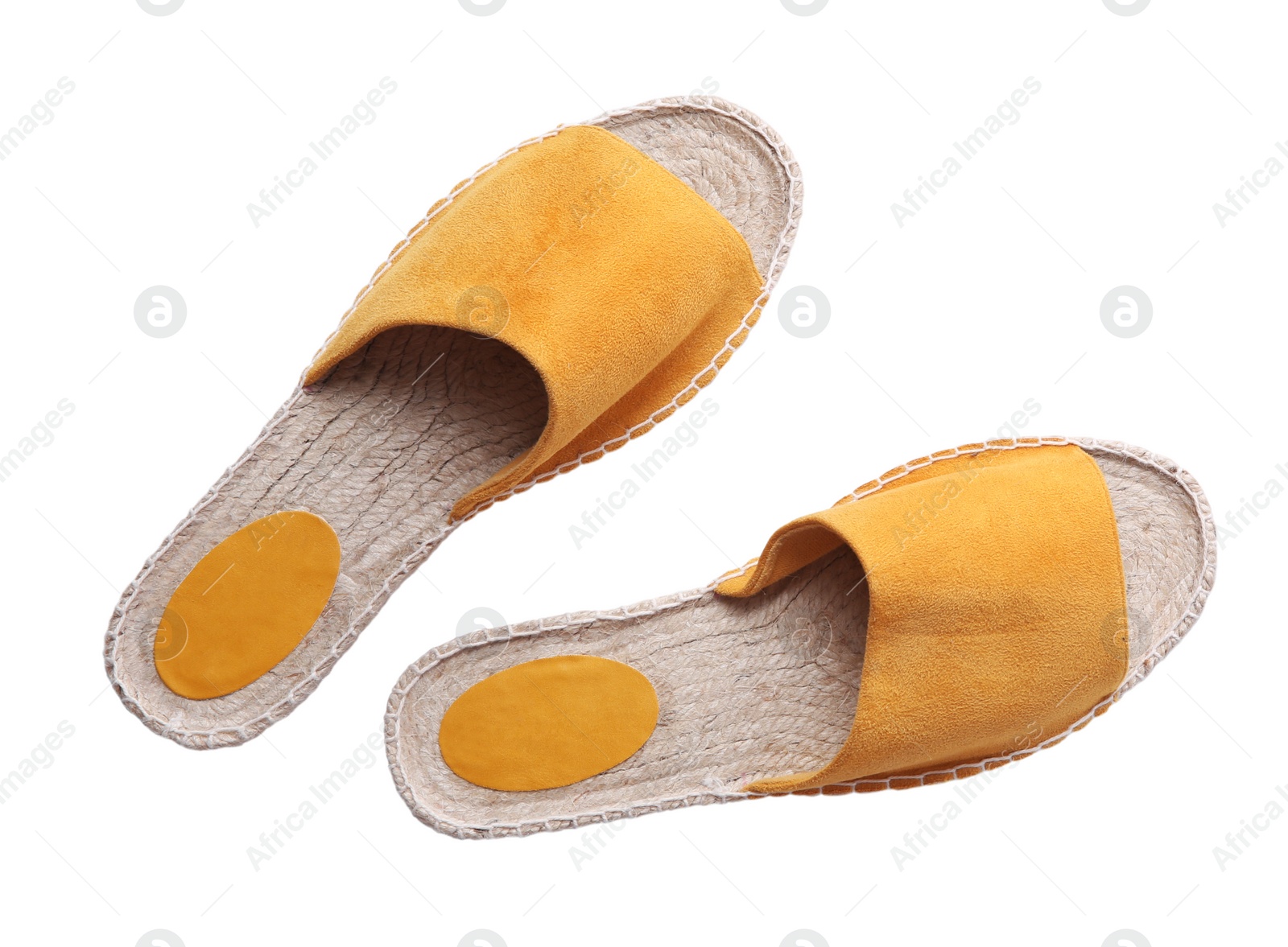 Photo of Stylish yellow shoes isolated on white, top view. Beach accessory