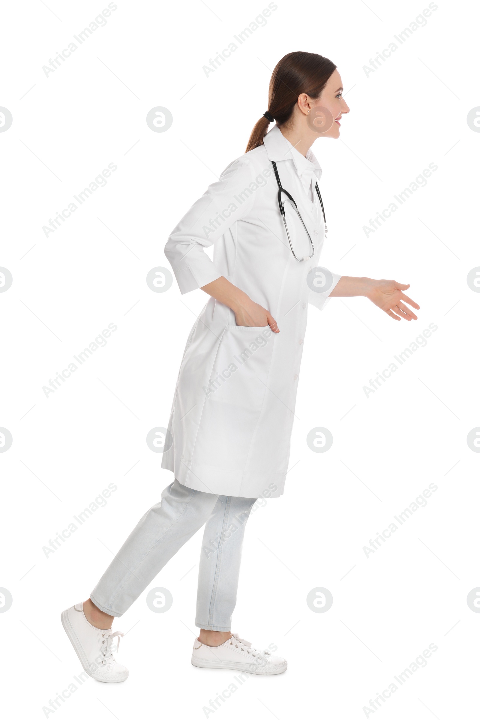 Photo of Doctor with stethoscope walking on white background
